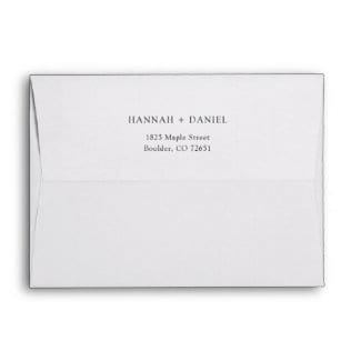 Plain black and white 5" x 7" wedding invitation envelope with names and return address on back flap