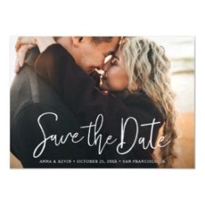 simple, modern horizontal wedding save the date magnet card with white typography and full photo
