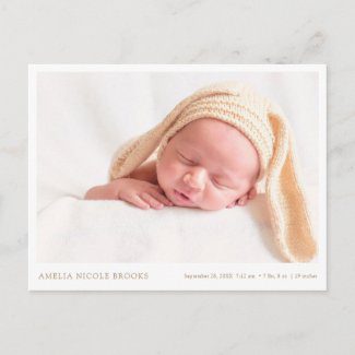 Simple birth announcement postcard with photo and gold text in horizontal format.
